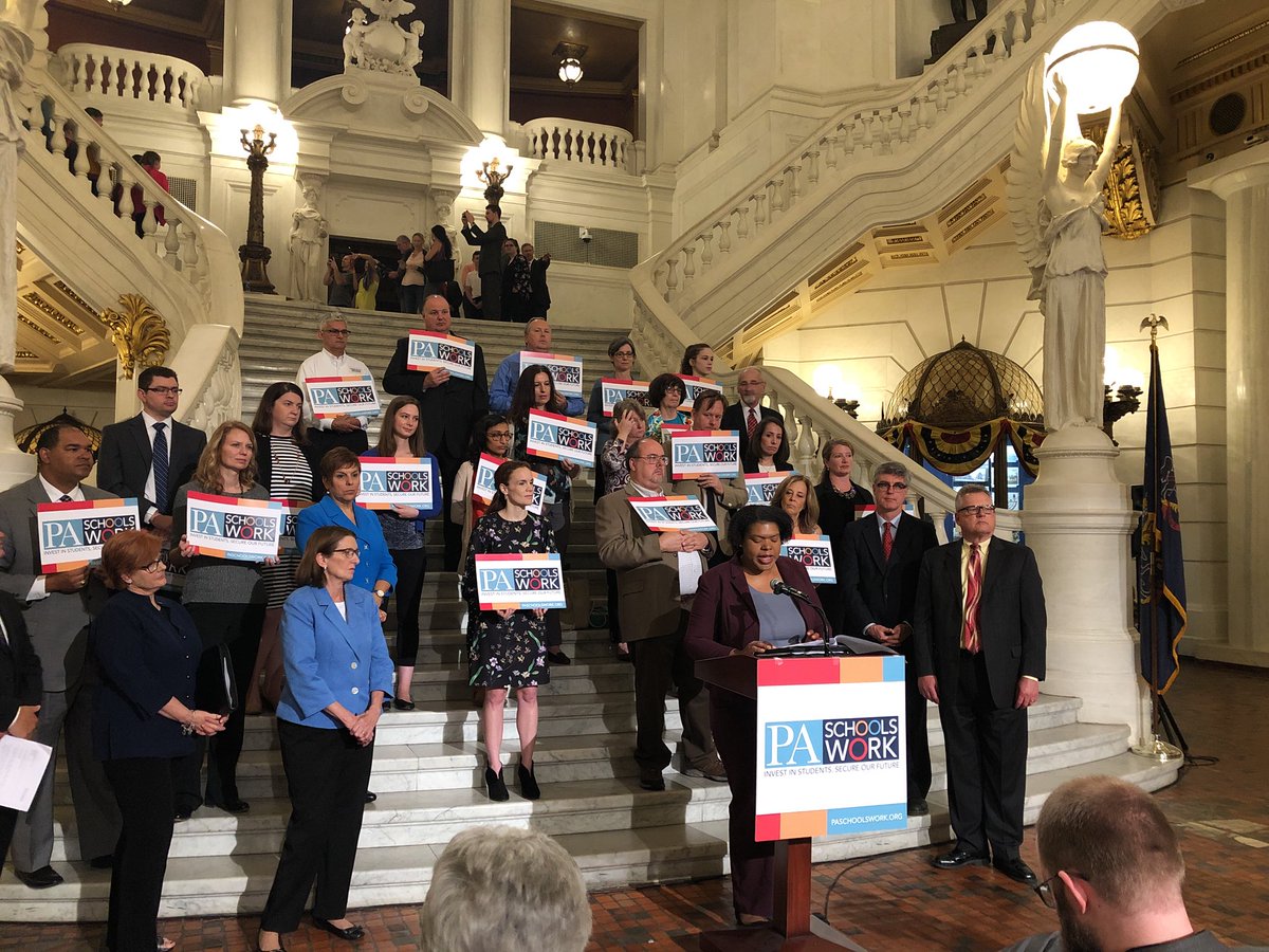 Educators stand on the steps in the Pennsylvania capital after increasing state education funding