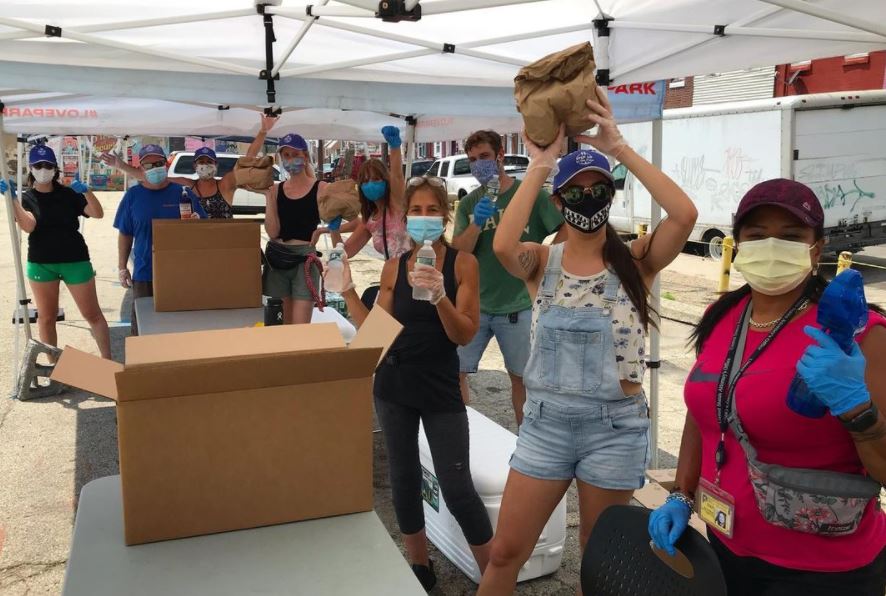 Group of people distributing food and water